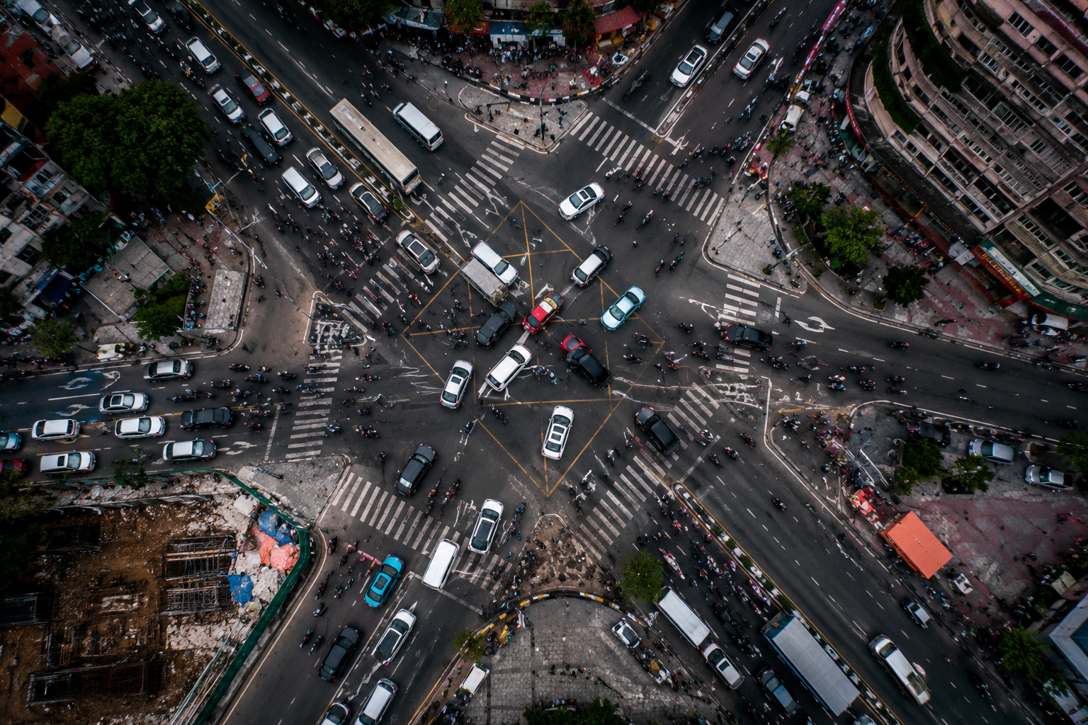 Aerial view of a chaotic, congested city intersection full of vehicles